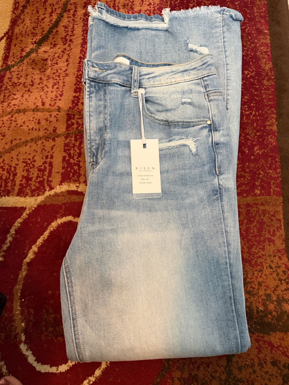Risen High rise distressed flare jeans featuring a front split hem